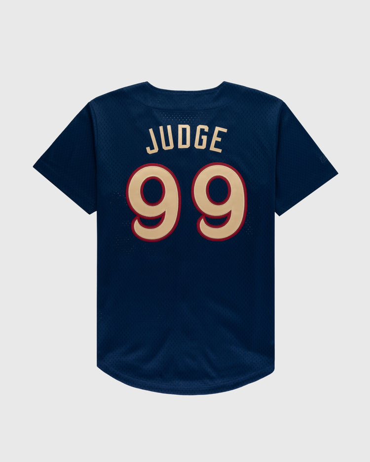The Ebbets Field AARON JUDGE BUTTON UP MESH JERSEY in navy features JUDGE and the number 99 in gold outlined in red on the back.