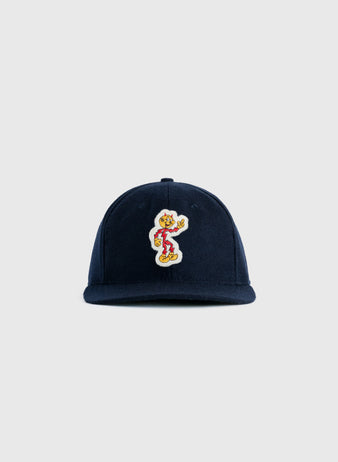 The EFF Reddy Kilowatt 1940 Authentic Wool Ballcap is a navy blue cap with a colorful patch of the vintage mascot skateboarding on the front, shown against a plain light gray background.