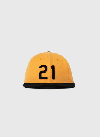 The Ebbets Field Flannels Roberto Clemente 1972 Signature Series Wool Ballcap features yellow wool, a black brim, and the number 21 in black on the front, set against a plain light gray background.