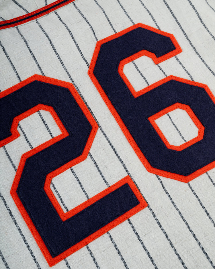 Close-up of the Ebbets Field San Francisco Seals 1938 Authentic Wool Home Baseball Jersey: white with thin navy blue pinstripes and large number 26 in navy outlined in red.