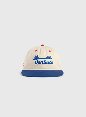 The Ebbets Field Santurce Cangrejeros Cotton Twill Ballcap features a cream crown, blue brim, red accents, Santurce in blue script, and two small blue horses—a classic tribute to Puerto Rican baseball.