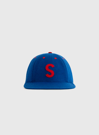 The EFF Seattle Rainiers 1938 Authentic 8-Panel Wool Ballcap features blue wool, red accents, and a red embroidered S, inspired by the classic Rainiers cap, displayed against a plain light gray background.