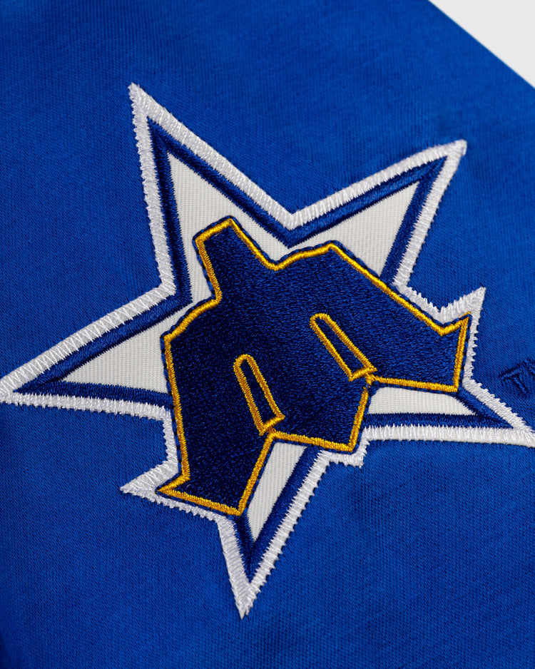 The EFF Seattle Mariners 1982 Satin Windbreaker Jacket features blue fabric with a white star outlined in blue and a bold yellow and navy M—ideal for fans of authentic MLB or vintage Mariners gear.