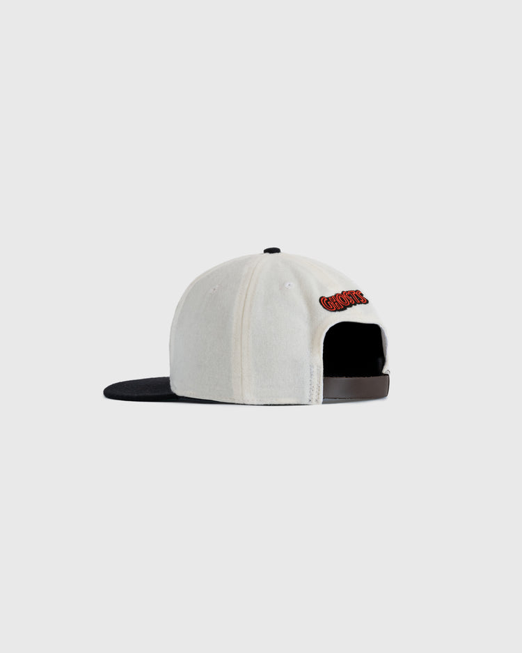 The EFF Sioux City Ghosts Two Tone Vintage Inspired Wool Ballcap is shown from the back in white with a black brim. It features an adjustable black strap, red and black embroidery above the opening, against a plain light gray background.