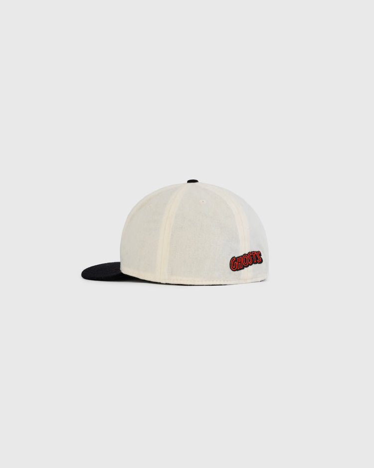 The EFF Sioux City Ghosts Two Tone Vintage Inspired Wool Ballcap features a cream crown, black brim, and GHOSTS embroidered in red on the back, echoing a 1935 design. Shown against a plain light gray background.