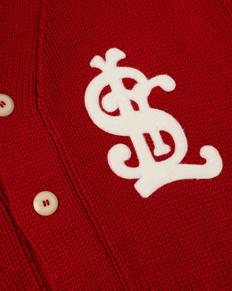 A close-up of the EFF St. Louis Cardinals 1908 Wool Shawl Collar Sweater, an authentic reproduction with cream-colored buttons and a large white chenille SL monogram patch on the left side.
