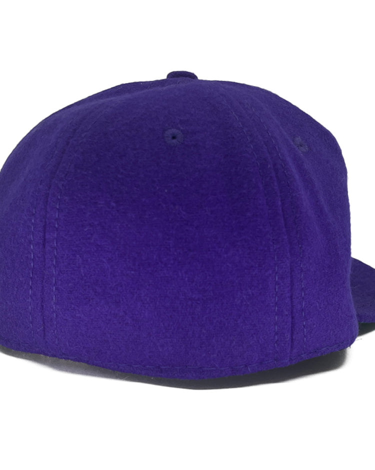 The EFF Texas Christian University 1963 Vintage Ballcap, made of genuine wool in purple, is shown from the back with visible stitching and a partially visible flat brim on the right side.