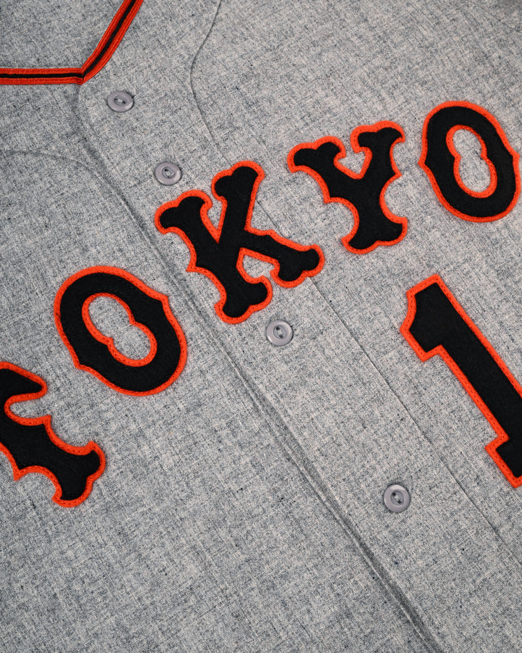 Close-up of the Tokyo Kyojin (Giants) 1961 Authentic Wool Road Baseball Jersey by Ebbets Field Flannels, featuring gray wool, black and red TOKYO lettering, button front, and a red-trimmed collar inspired by Sadaharu Oh’s iconic style.