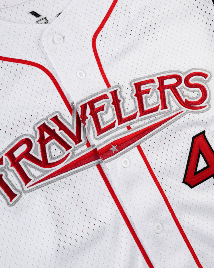 Close-up of the Ebbets Field JULIO RODRIGUEZ BUTTON UP MESH JERSEY in white/black, featuring bold lettering across the chest and part of the number 4 visible on the right side.