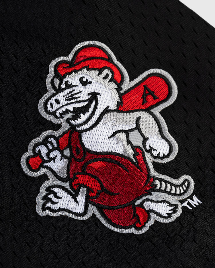 The JULIO RODRIGUEZ BUTTON UP MESH JERSEY WHT/BLK by Ebbets Field features an embroidered cartoon opossum in red overalls, hat, and holding a red baseball bat on a black textured fabric background.
