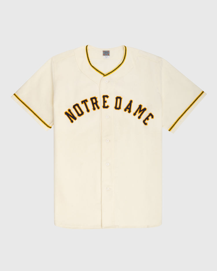 The Ebbets Field University of Notre Dame 1956 Authentic Wool Home Baseball Jersey features vintage short sleeves, cream color, bold black and yellow NOTRE DAME lettering, and yellow trim—a true Fighting Irish classic.