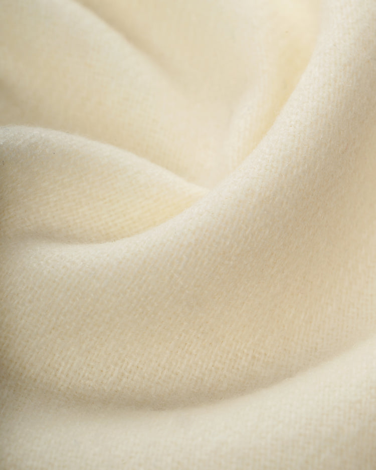 Close-up of the soft, cream-colored wool fabric with smooth, gentle folds from the Ebbets Field University of Notre Dame 1956 Authentic Home Baseball Jersey.