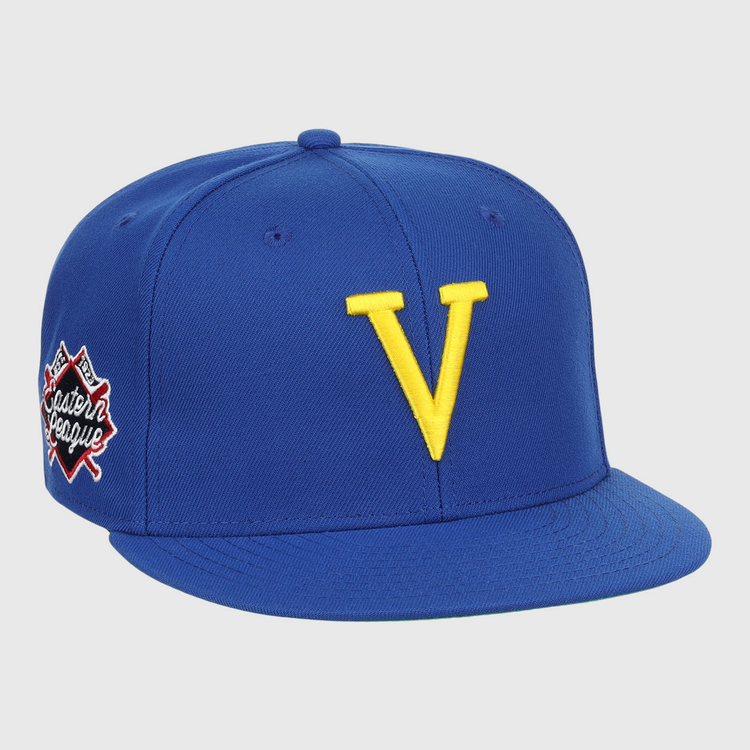 The Vermont Mariners EFF MiLB Vintage Snapback by Ebbets Field Flannels features a blue adjustable cap with a bold yellow V front and an Eastern League patch—perfect for Vermont Mariners fans and vintage collectors.