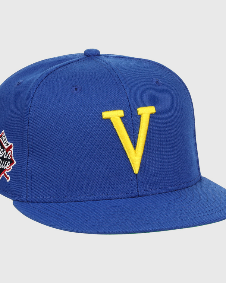The Vermont Mariners EFF MiLB Vintage Snapback by Ebbets Field Flannels features a blue adjustable cap with a bold yellow V front and an Eastern League patch—perfect for Vermont Mariners fans and vintage collectors.