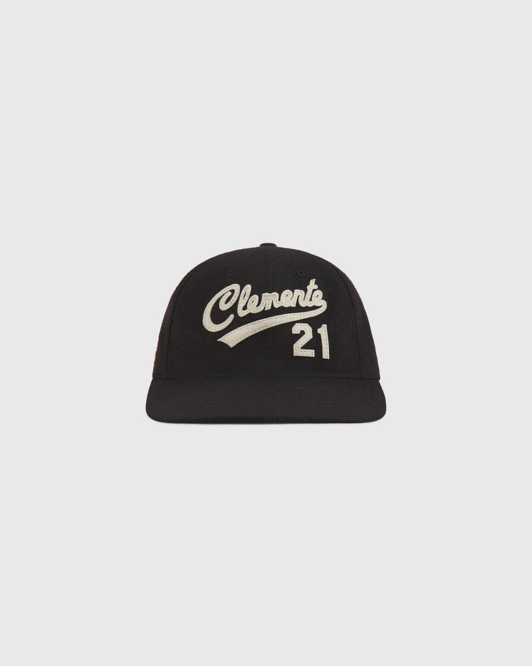Introducing The Clemente Museum X Ebbets Field Wool Ballcap by Ebbets Field—a black wool cap featuring white script embroidery of “Clemente” and the number 21 on the front. Part of the exclusive Clemente collection, this ballcap is shown against a simple, light background and honors the iconic Roberto Clemente Museum.