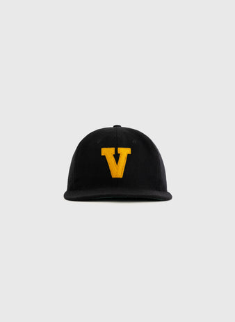 The EFF Vanderbilt University 1960 Authentic Wool Ballcap is a black vintage cap with a large yellow V embroidered on the front, displayed against a plain light gray background.