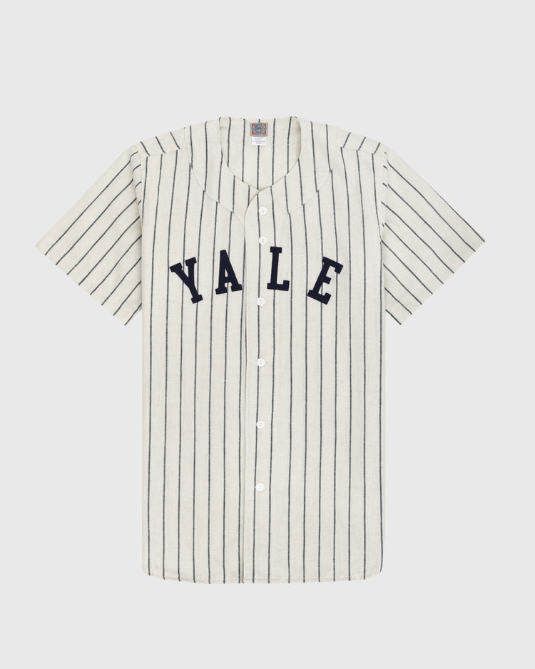 The Ebbets Field Yale University 1948 Authentic Wool Home Baseball Jersey is vintage-style, white with thin black stripes, short sleeves, bold navy YALE lettering on the chest, and classic white front buttons.