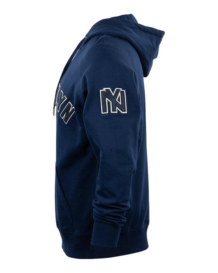 Side view of the EFF Brooklyn Eagles French Terry Script Hooded Sweatshirt in navy blue, featuring an NY sleeve patch, script chest letters, and a Newark Eagles heritage nod, displayed on a plain white background.