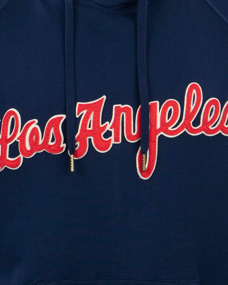Close-up of the EFF Los Angeles (PCL) French Terry Script Hooded Sweatshirt in navy with Los Angeles in red cursive outlined in white—a tribute to the Angels and iconic moments like the 1942 PCL playoffs.