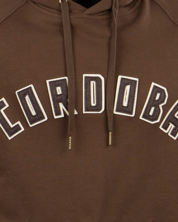 The EFF Cordoba Cafeteros French Terry Script Hooded Sweatshirt features bold, white and black outlined CORDOBA lettering across the chest—honoring legendary Mexican baseball figure Jorge Pasquel.
