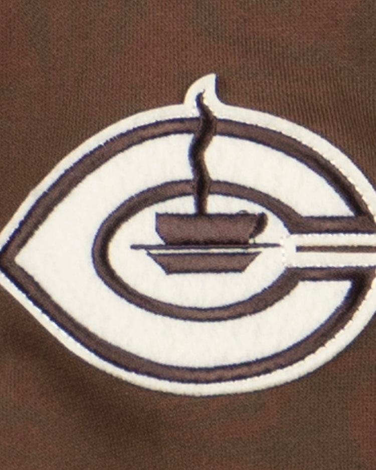 The EFF Cordoba Cafeteros French Terry Script Hooded Sweatshirt showcases a brown and white embroidered patch with a stylized C and steaming soup bowl, honoring Mexican baseballs legacy. Brown fabric provides the perfect backdrop.