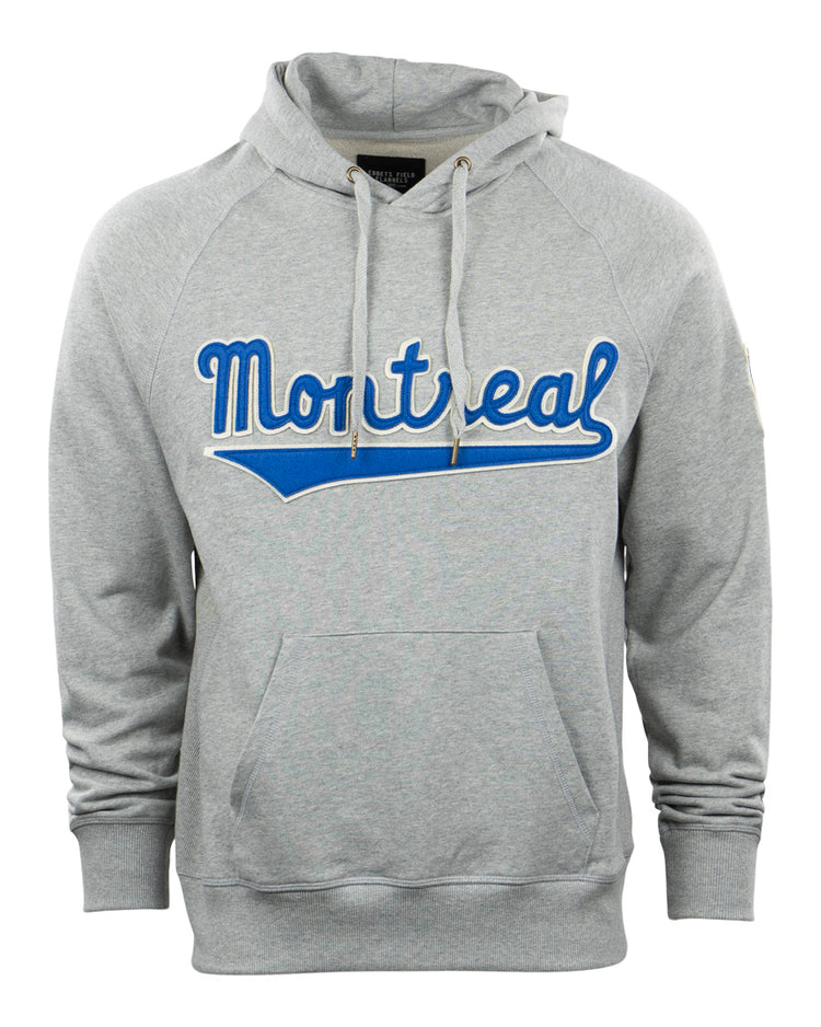 The EFF Montreal Royals French Terry Script Hooded Sweatshirt is light gray with a front pocket and bold blue and white Montreal script across the chest, paying subtle homage to legends like Roberto Clemente.