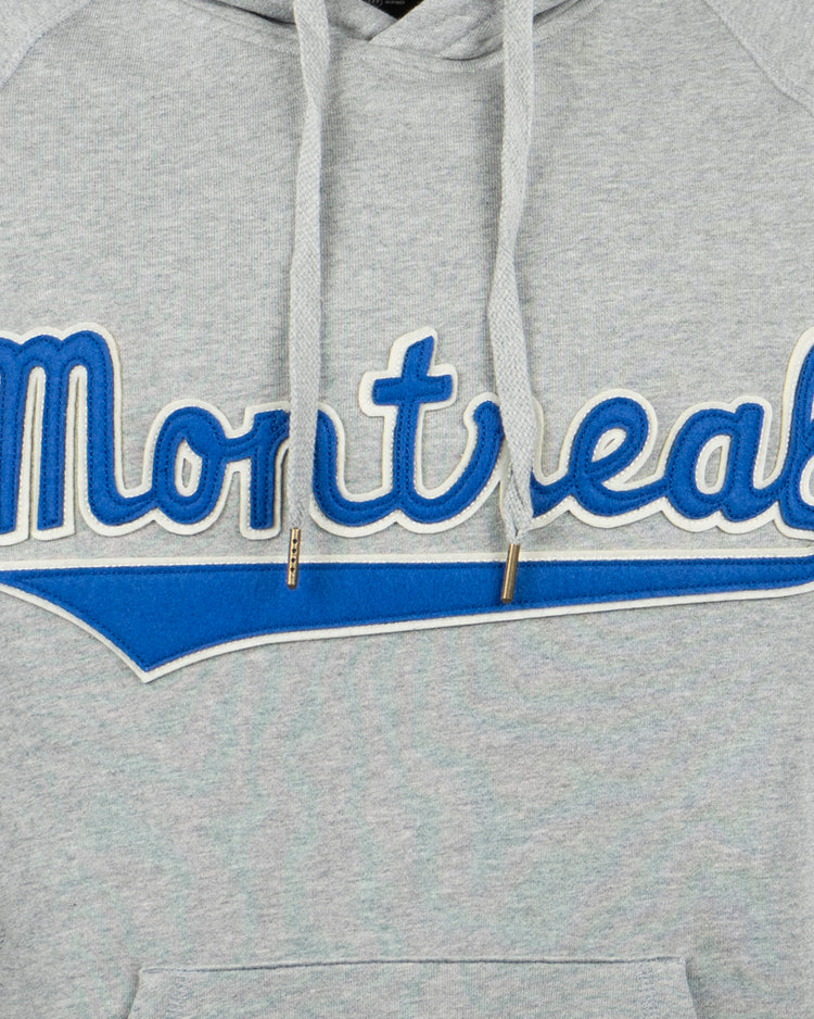 The EFF Montreal Royals French Terry Script Hooded Sweatshirt is a grey hoodie featuring Montreal in blue and white script with a blue underline, inspired by classic sports legends.