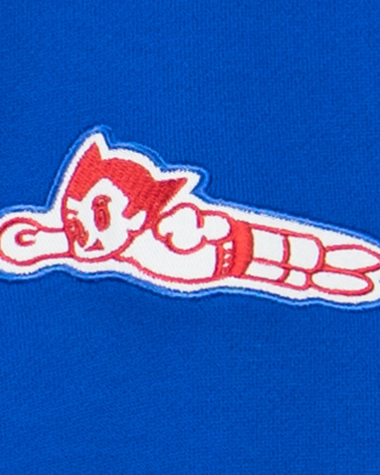 A red and white cartoon patch of Atom Boy on a bright blue background—perfect for fans of the Sankei Atoms French Terry Script Hooded Sweatshirt by EFF.