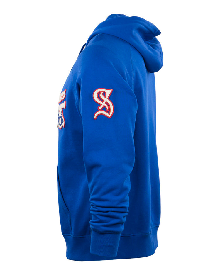 The EFF Santurce Cangrejeros French Terry Script Hooded Sweatshirt in royal blue is shown from the side, with a red and white embroidered logo on the upper arm and a partial front pocket visible.