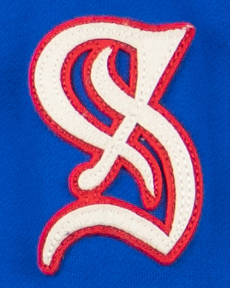 The EFF Santurce Cangrejeros French Terry Script Hooded Sweatshirt in royal blue features a white and red embroidered interlocking S and L logo, inspired by the vibrant style of the Puerto Rican League.