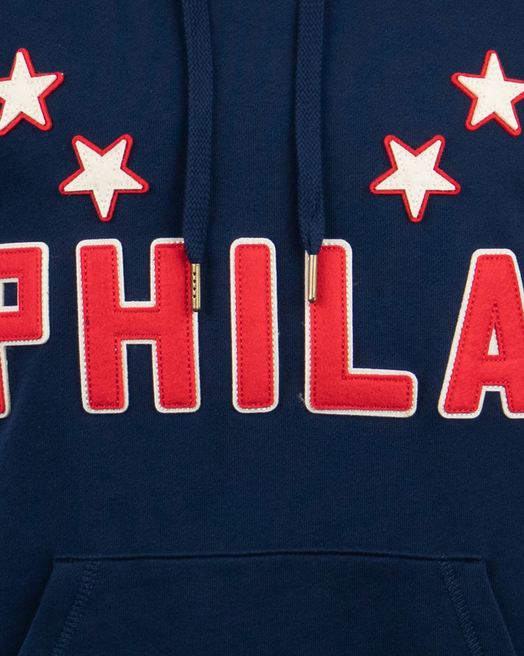 The EFF Philadelphia Stars French Terry Script Hooded Sweatshirt features a navy blue design with red and white stars, bold PHILA script, drawstrings, and a front pocket—honoring the Hilldale Club’s pursuit of the NNL pennant.