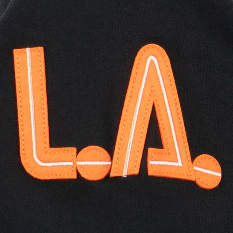 The Los Angeles Aztecs French Terry Script Hooded Sweatshirt by EFF features bold, orange L.A. letters with white accents on black fabric, inspired by the iconic North American Soccer League team where George Best played.