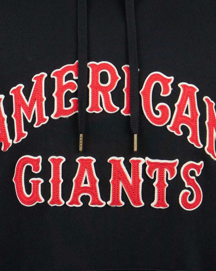 A close-up of the EFF Chicago American Giants French Terry Script Hooded Sweatshirt, featuring bold red and white lettering honoring Rube Foster and the Negro National League, with black drawstrings tipped in gold.