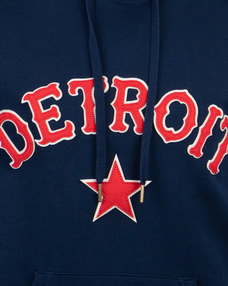 The EFF Detroit Stars French Terry Script Hooded Sweatshirt features DETROIT in bold red and white letters with a large red star outlined in white, celebrating the legacy of the Negro National League’s Detroit Stars.