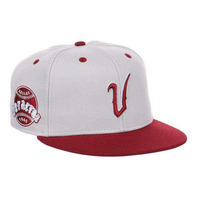 The EFF Veracruz Azules NLB Storm Chasers Fitted Ballcap features a storm gray crown, white panels, red brim and button, a bold red V logo, and a side patch honoring the Mexican League.