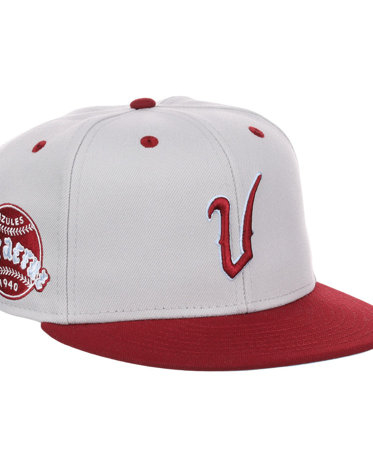 The EFF Veracruz Azules NLB Storm Chasers Fitted Ballcap features a storm gray crown, white panels, red brim and button, a bold red V logo, and a side patch honoring the Mexican League.