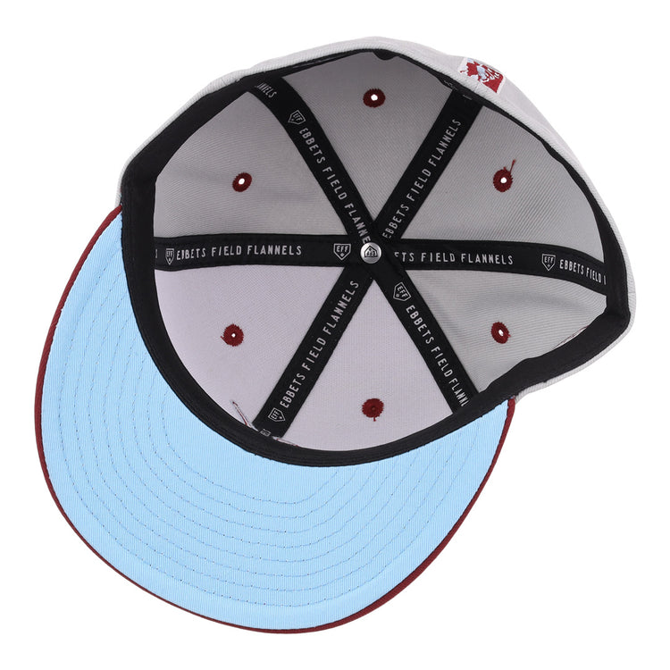 The image shows the inside of the EFF Veracruz Azules NLB Storm Chasers Fitted Ballcap, featuring a light blue brim, white crown with red stitching and embroidered dots, plus a black sweatband labeled Ebbets Field Flannels.