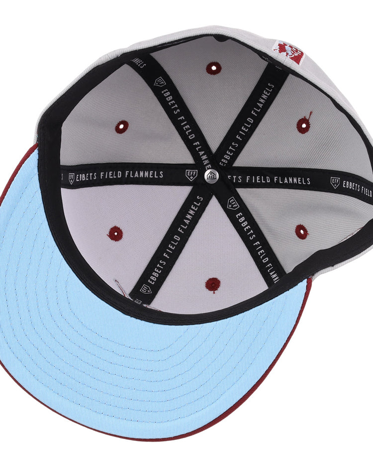 The image shows the inside of the EFF Veracruz Azules NLB Storm Chasers Fitted Ballcap, featuring a light blue brim, white crown with red stitching and embroidered dots, plus a black sweatband labeled Ebbets Field Flannels.