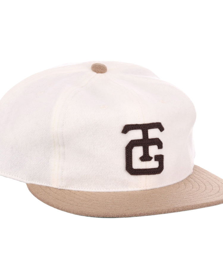 The EFF Tokyo Kyojin (Giants) Vintage Inspired Ballcap in cream features a beige brim, brown top button, and bold black overlapping TC logo—paying tribute to the classic Tokyo Giants tradition.