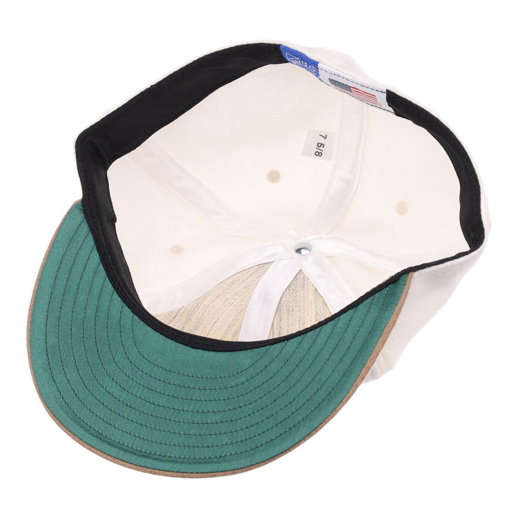 The image shows the inside of the EFF Tokyo Kyojin (Giants) Vintage Inspired Ballcap - Cream, featuring a green underbrim, black sweatband, white lining, size tag 7 5/8, and a blue label referencing the Kyojin.