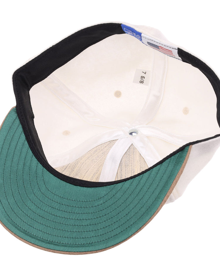 The image shows the inside of the EFF Tokyo Kyojin (Giants) Vintage Inspired Ballcap - Cream, featuring a green underbrim, black sweatband, white lining, size tag 7 5/8, and a blue label referencing the Kyojin.