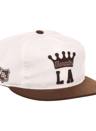 The EFF Los Angeles Monarchs Vintage Inspired Ballcap is a white wool cap with a brown brim, featuring Monarchs LA and crown logo on the front and a WHL shield patch on the side.