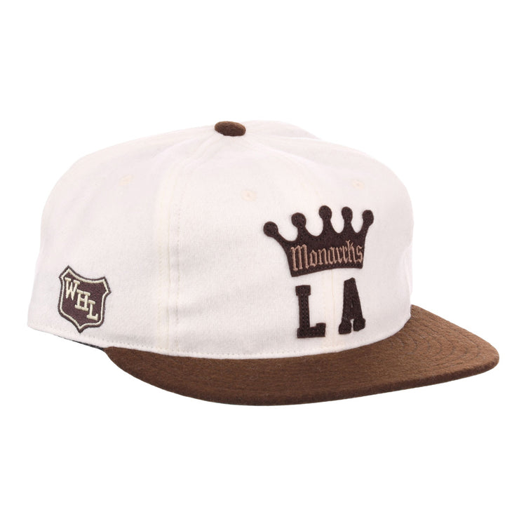 The EFF Los Angeles Monarchs Vintage Inspired Ballcap is a white wool cap with a brown brim, featuring Monarchs LA and crown logo on the front and a WHL shield patch on the side.