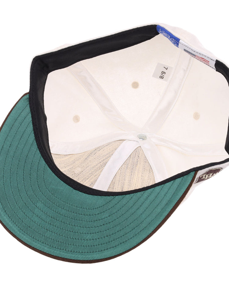 The image shows the inside of an EFF Los Angeles Monarchs Vintage Inspired Ballcap featuring a green undervisor, black sweatband, and size label (7 5/8), highlighting its classic wool baseball cap construction.