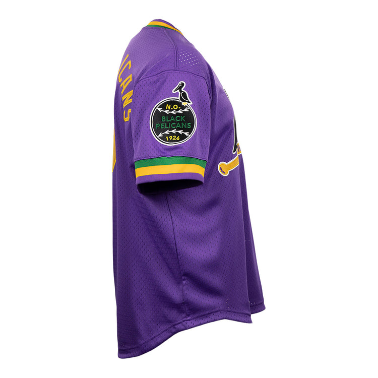The EFF New Orleans Black Pelicans Vintage Inspired NL Replica V-Neck Mesh Jersey features purple mesh with yellow, green, and white trim, plus a 1926 bird patch on the left sleeve. Shown from a side angle.