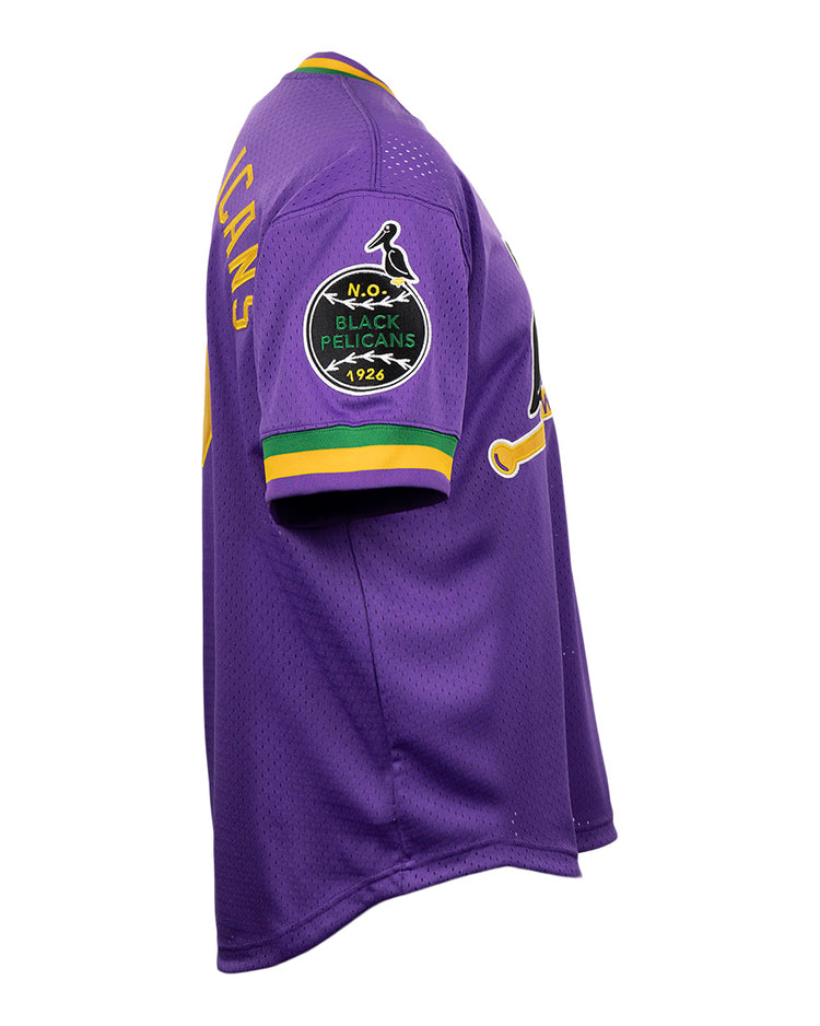 The EFF New Orleans Black Pelicans Vintage Inspired NL Replica V-Neck Mesh Jersey features purple mesh with yellow, green, and white trim, plus a 1926 bird patch on the left sleeve. Shown from a side angle.