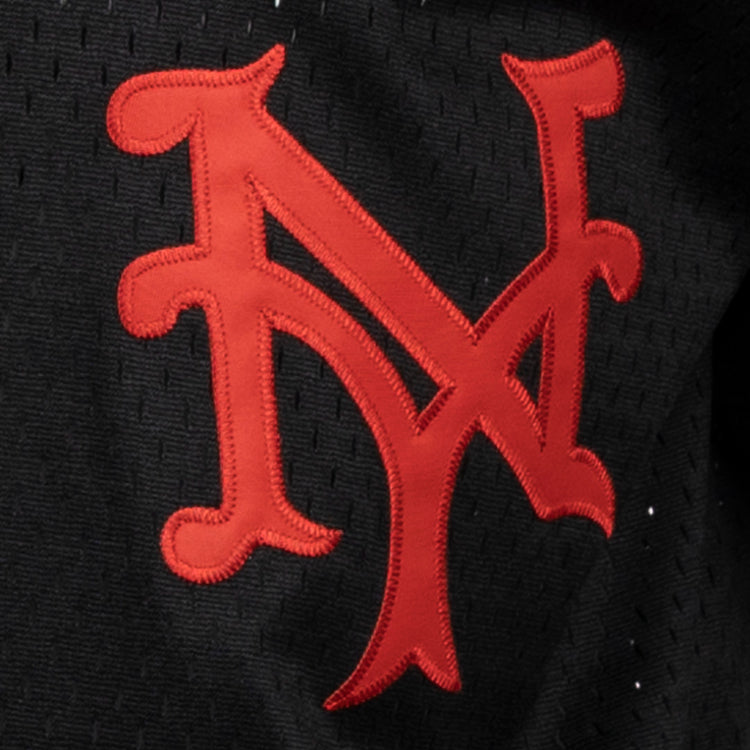 A red, stylized NY logo is stitched on black fabric, celebrating the New York Mets in classic style. This EFF Negro League Allover Vintage Inspired NL Replica V-Neck Mesh Jersey features a retro look reminiscent of vintage mesh jerseys.