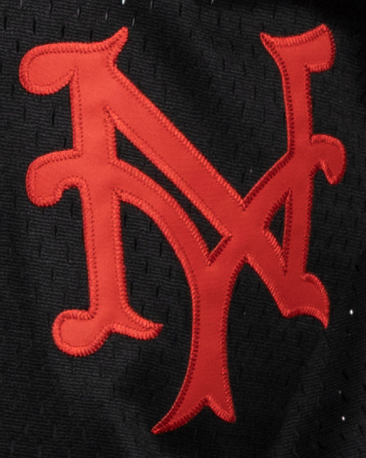 A red, stylized NY logo is stitched on black fabric, celebrating the New York Mets in classic style. This EFF Negro League Allover Vintage Inspired NL Replica V-Neck Mesh Jersey features a retro look reminiscent of vintage mesh jerseys.