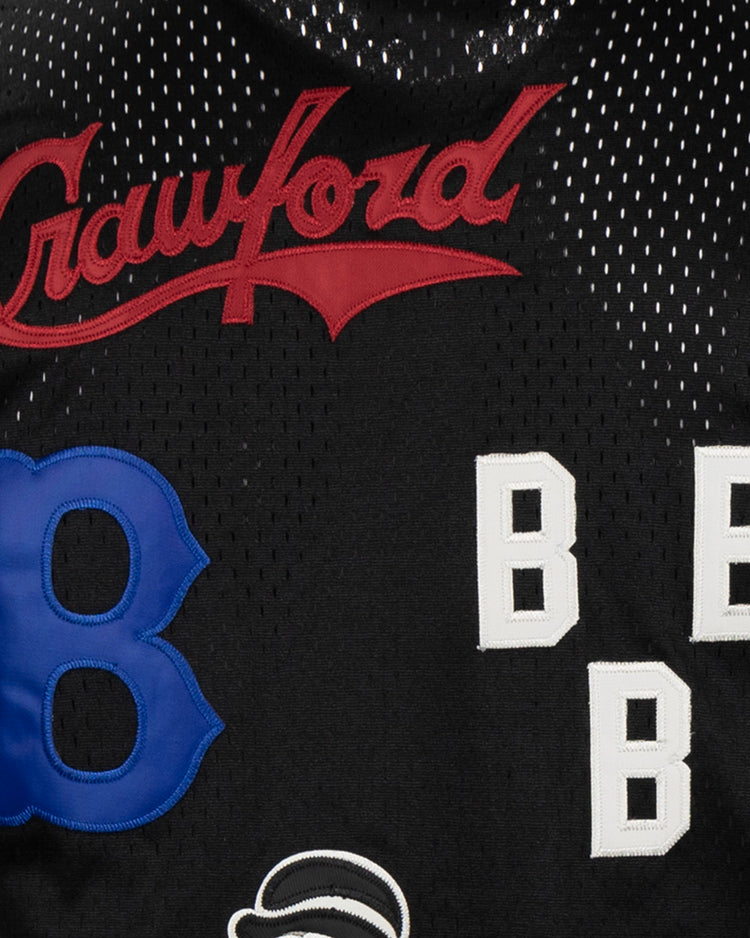 Close-up of the EFF Negro League Allover Vintage Inspired NL Replica V-Neck Mesh Jersey in black, featuring red Crawford script, a large blue B, three white block Bs, and part of another patch—a tribute to Negro League Baseball.