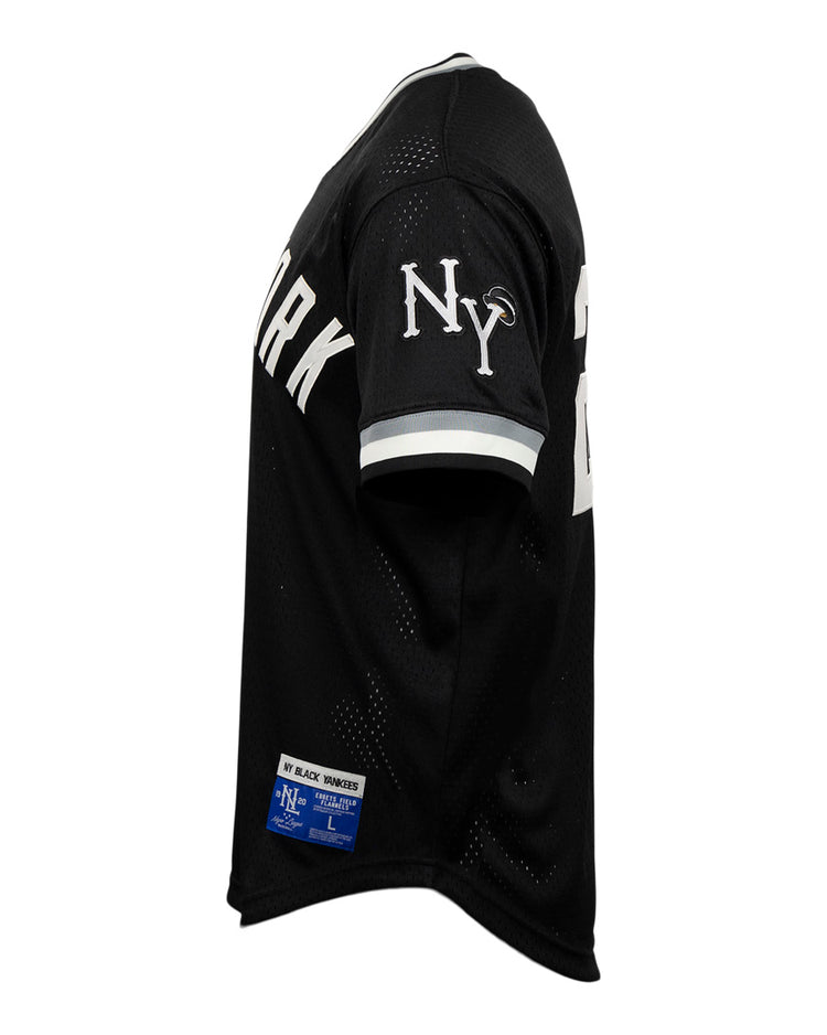 EFF New York Black Yankees Vintage Inspired NL Replica V-Neck Mesh Jersey in black, shown from the side with a white NY sleeve logo, white cuff stripes, and partially visible NEW YORK lettering—honoring Negro National League history.